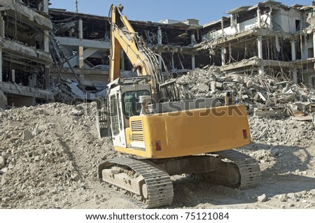 shovel digger tearing down a business building