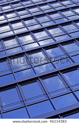 Detail of a bureau building, facade with reflecting sky
