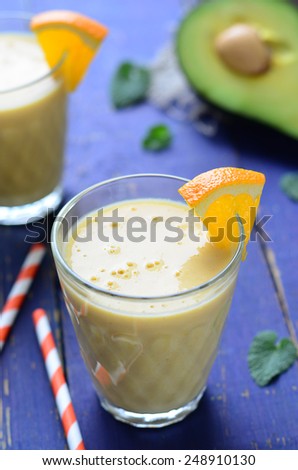 Healthy smoothie with orange, banana and avocado, vertical