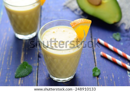 Healthy smoothie with orange, banana and avocado, horizontal