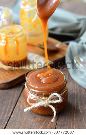 Homemade Caramel Sauce Melted; Salted Caramel, selective focus, vertical