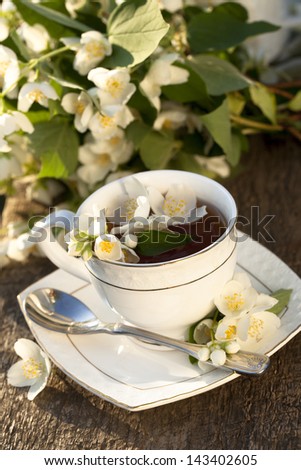 Cup of jasmine tea and jasmine flowers
