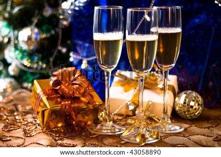 Glasses of champagne with gold ribbon gifts