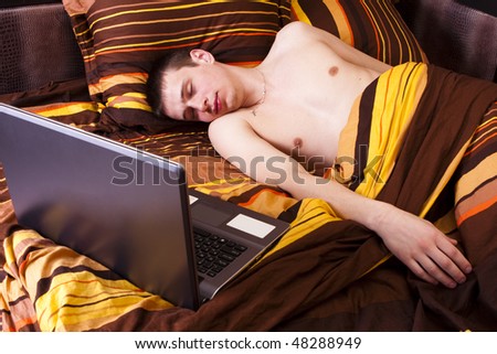 young boy fell asleep next to laptop