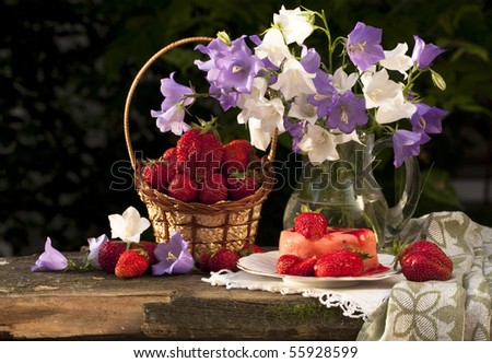 Still life with bouquet of flowers and strawberry cake