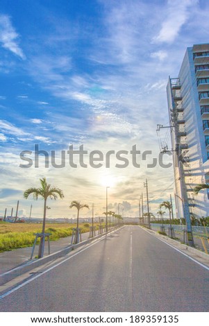Sun and blue sky with asphalt road