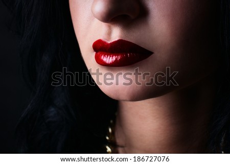 red lips brunette, on a black background