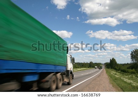 Green truck on a country road