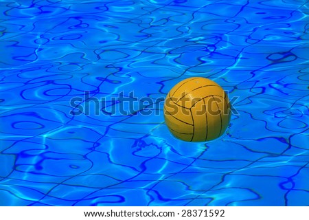 Yellow water polo ball on blue water background