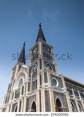 Looking up the twin towers of the Cathedral of the Immaculate Conception in Chanthaburi town under a blue sky. Thailand.