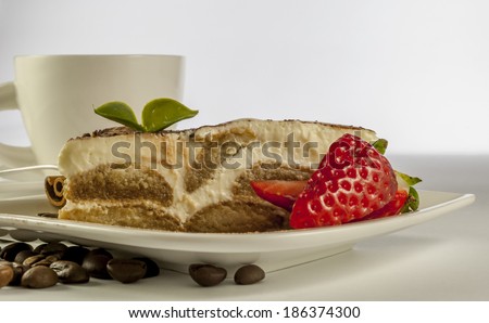 italian desert tiramisu with coffe and strawberry on white background