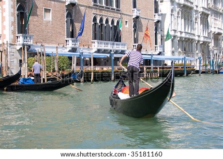 Two gondoliers on the Canal Grande of Venice, Italy.