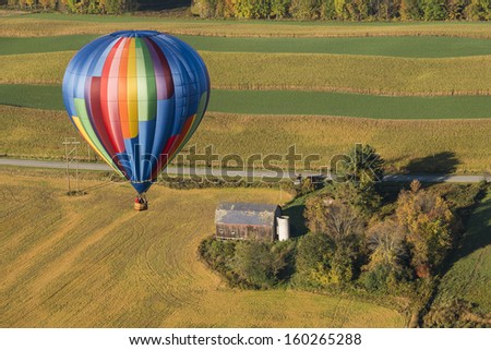 Hot Air Balloon Flying Over The Farm Landscape In Beautiful New York State