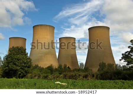The cooling towers of a power station against a blue sky