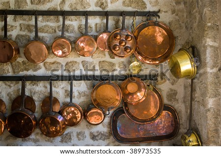 A collection of brass pans in an ancient kitchen