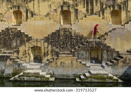 Local Women crossing the stepwells of Chand Baori, in Jaipur, India. It was built as a monument to the goddess of joy and happiness, Hashat Mata.