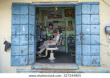 Pushkar, India-March 22, 2014:Unidentified local people in the barber shop in the street of Pushkar.