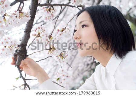 Young woman under the cherry tree