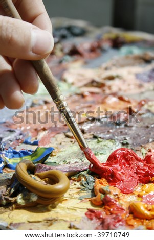 mixing of paint a brush on a palette