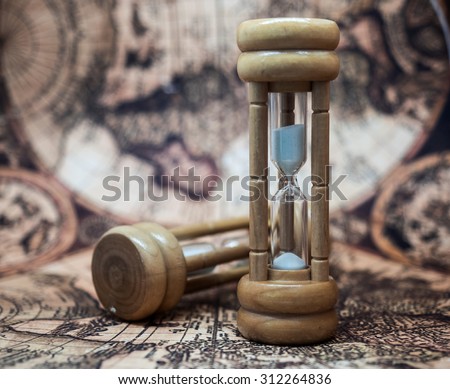 Sandglass, Hourglass, Sand Timer, Sand Clock on Antique World Map Background.