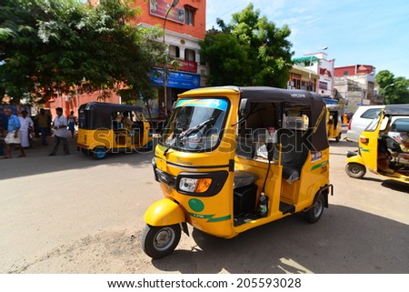 Chennai INDIA - JULY 27, 2013: Auto yellow rickshaw taxis on a road in Chennai, India.