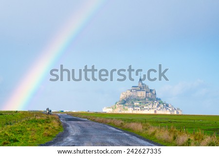 rainbow near Mont St Michel touristic attraction of northern France in retro style - Famous historic place of French