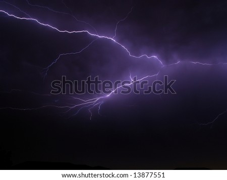 Big scary lightning storm on a stormy night with house rooftops