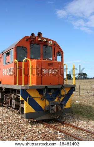 Orange train engine in the country side