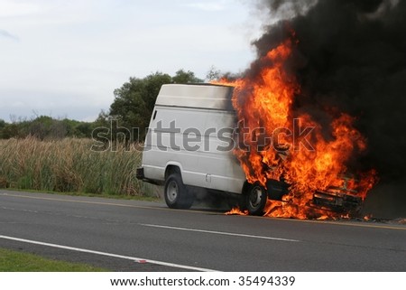 Truck or van burning creating large flames and smoke