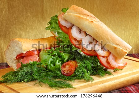 Sandwiches with fish and shrimps on wooden board close-up