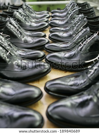 Fashionable man's a boot in shoe shop