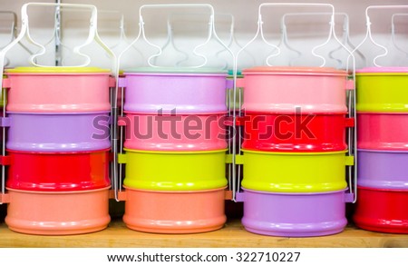 colorful Asian pinto lunch containers for rice and food for sale in a market