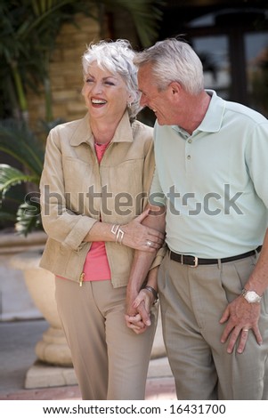 Seniors walking and holding hands