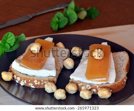 Quince And Fresh White Cheese On Bread Toast On A Brown Plate On The Wooden Table