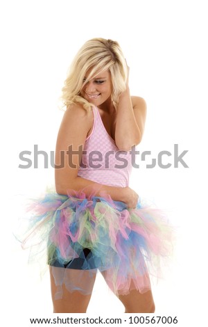 A woman in her pink and multi-colored tutu with a peaceful feeling about her