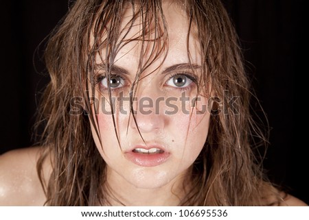 A close up of a woman\'s face with sweat running down her face