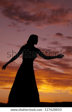 A silhouette of a woman reaching out.