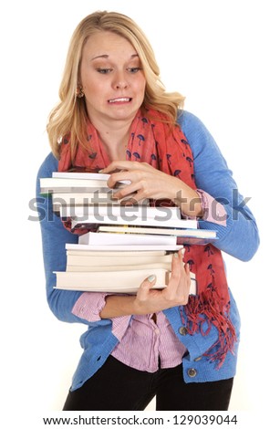 A woman about ready to drop her stack of books