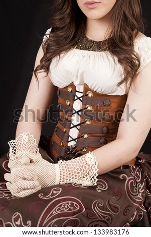 a woman in her vintage western dress with her hands in her lap