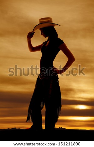 A silhouette of a woman in her western wear.