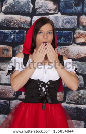 A woman shocked in her red riding hood outfit.