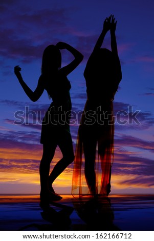 A silhouette of two women dancing together.