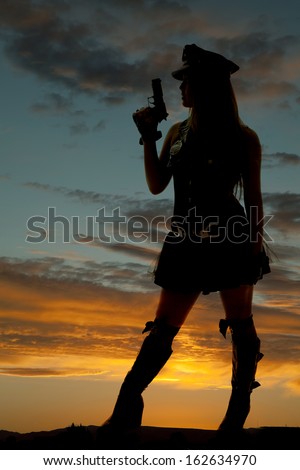 A silhouette of a female cop holding up a gun.