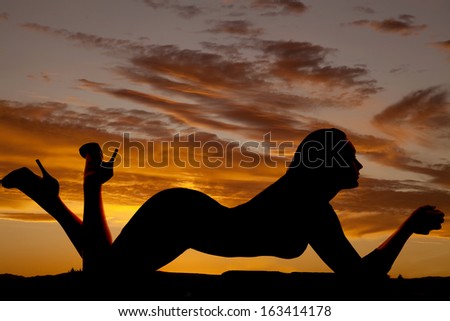 a silhouette of a woman laying down showing off her figure.