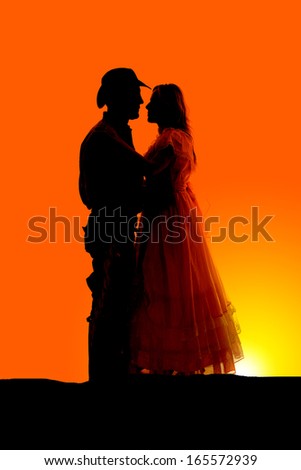 a silhouette of couple in their western clothes.
