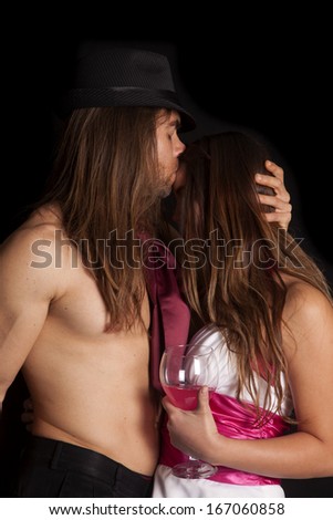 A man is kissing a woman on the forehead.