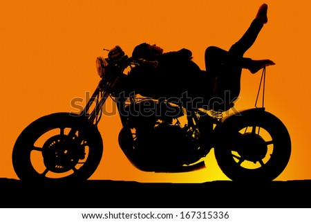 A woman laying back on a motorcycle in the sunset with her feet up