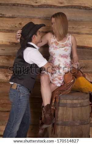 A western couple is looking at each other and smiling.