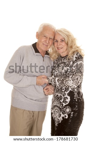 an elderly couple holding each other with their heads together.