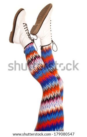 A woman legs with colorful pants up in the air.